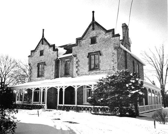 A black and white photo of a large brick house